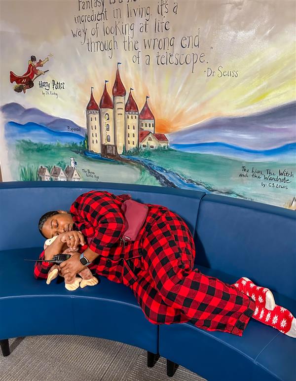 principal sleeping on couch in red pajamas